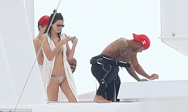kendall jenner takes picture of lewis hamilton on superaycht axioma