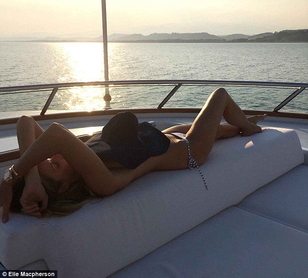 elle macpherson posing on superyacht madsummer with husband