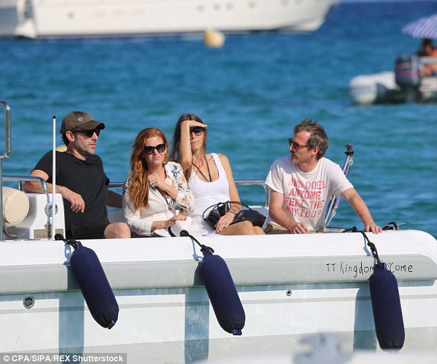 comic sacha baron cohen and actress isla fisher travel by tender to bono's luxury yacht 'kingdom come'